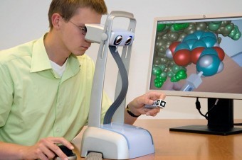 The user interacts with the virtual environment with a manipulator, with which he can influence the molecules.